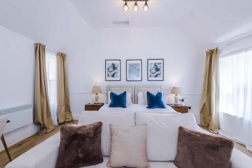 a bedroom with a white bed with blue pillows at Westminster House Studio - By Assured Stays in Hull