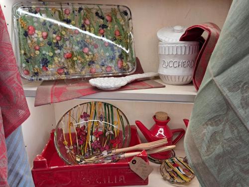 a shelf with a red container and other items at Hotel Minerva in Siena