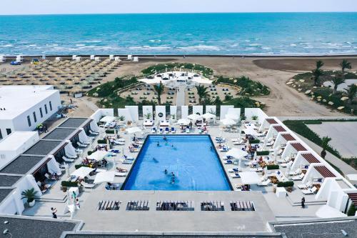 an aerial view of a resort with a pool and the ocean at Sea Breeze Resort, Beachfront apartment with a balcony and sea view in Nardaran