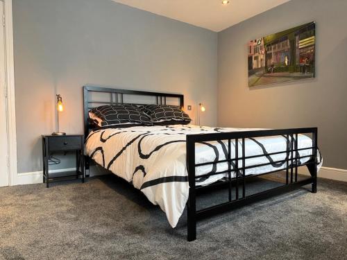 a bedroom with a bed with a black metal frame at Apartment in the Heart of Buxton in Buxton