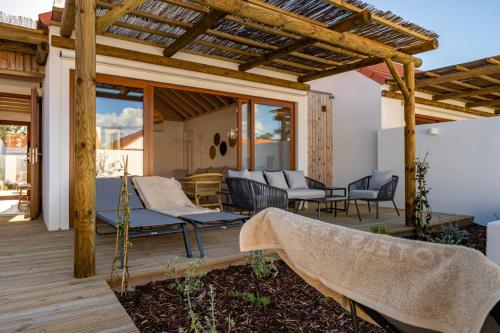 a patio with chairs and a pergola at Pestana Comporta Village Residences in Comporta