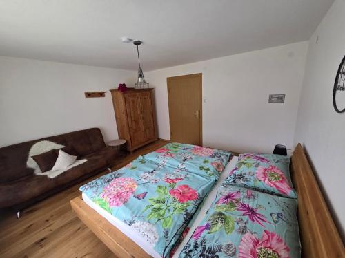 a bedroom with a bed and a couch in it at Haus Martinsklause in Musau