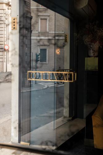a door to a building with a sign on it at Otivm Hotel in Rome