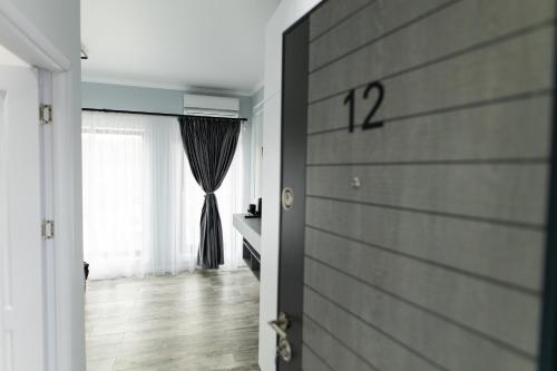 a door leading to a room with a window at TisArt Hotel in Tismana
