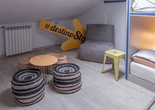 a room with a bed and a table and stools at Santiago KM-0 in Santiago de Compostela