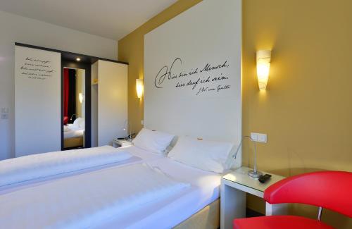 Ένα ή περισσότερα κρεβάτια σε δωμάτιο στο Hotel Alte Schule