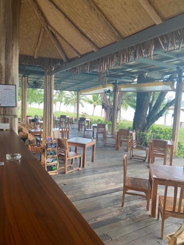 a restaurant with wooden tables and wooden chairs at Better View Koh Yao Yai in Ko Yao Yai