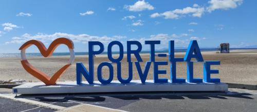 a sign that saysporta novoille in front of a beach at Bungalow Confort et Nature in Port-la-Nouvelle