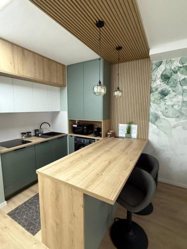 a kitchen with a wooden counter top in a room at Sugo Studio Apartman in Baja