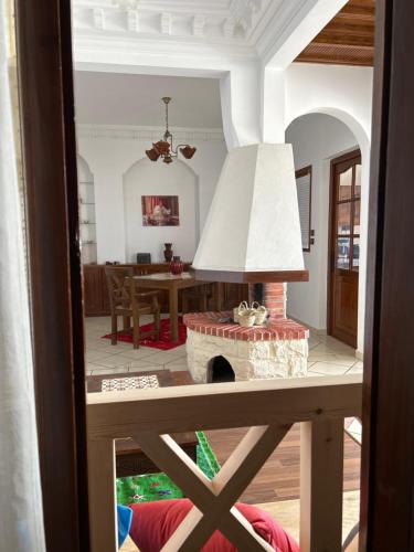a living room with a fireplace and a table at Blue pearl Mogador in Essaouira