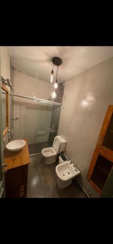 a bathroom with two toilets and a sink at Casa amplia en Costanera in Posadas