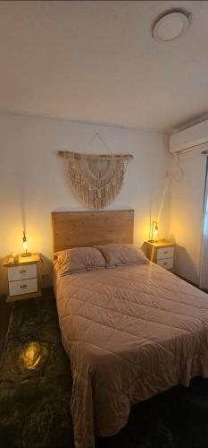 a bedroom with a bed with a chandelier above it at Casa amplia en Costanera in Posadas