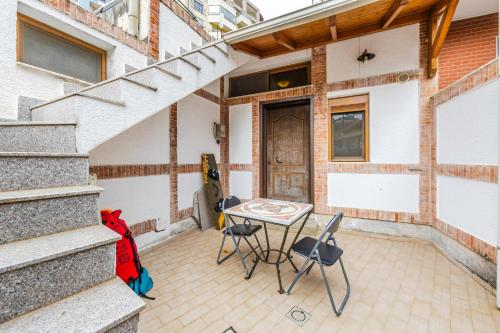 a patio with a table and chairs in front of a building at Mbreti Monun in Durrës