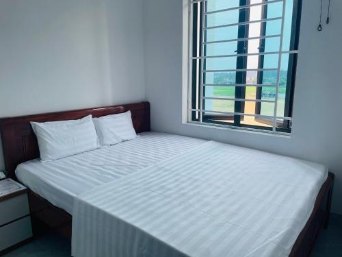Postel nebo postele na pokoji v ubytování Hoàng Anh Hotel
