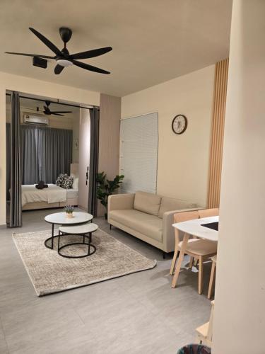a living room with a couch and a ceiling fan at dgunduls homestay SUNSURIA SOHO by DGH in Shah Alam