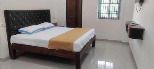 a bedroom with a bed in a room at SSK Rooms in Gūduvāncheri