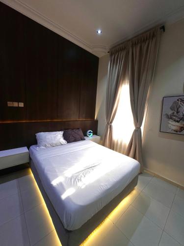 a bedroom with a large bed with a window at Premium 2-bedroom apartment in Lekki phase one in Lekki