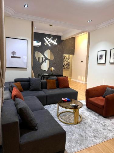 a living room with a couch and a table at Premium 2-bedroom apartment in Lekki phase one in Lekki
