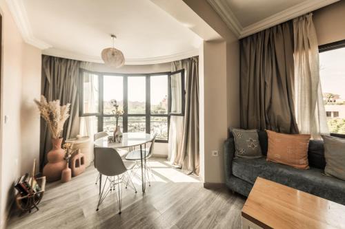a living room with a couch and a table at Amani Hotel Suites & Spa in Marrakech