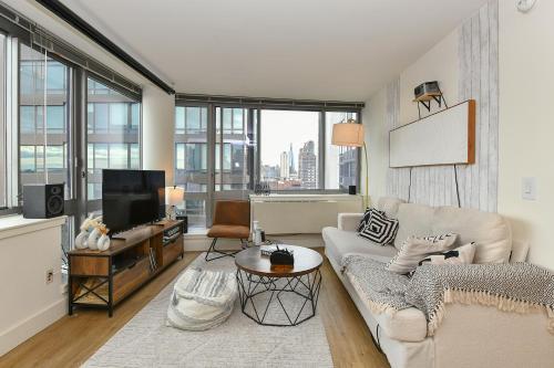a living room with a couch and a tv at Modern Times Square 1 BR Retreat in New York