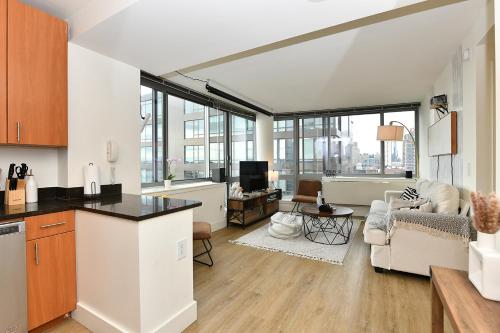 a kitchen and living room with a large window at Modern Times Square 1 BR Retreat in New York