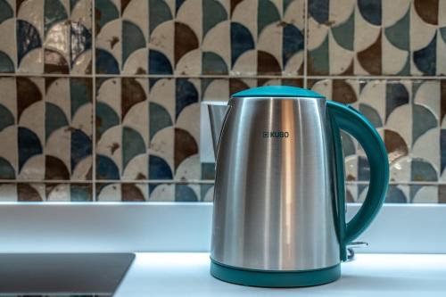 a teapot sitting on a counter next to a laptop at Tres Alturas de Calma in Buitrago del Lozoya