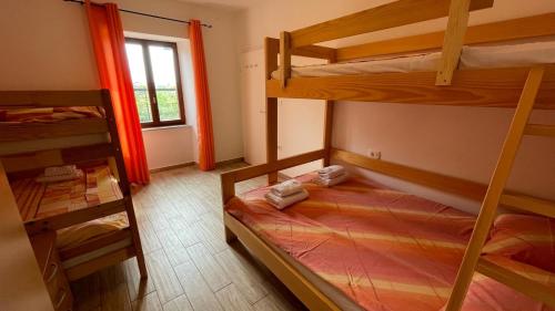 a bedroom with two bunk beds and a window at Hišica na morju in Ankaran