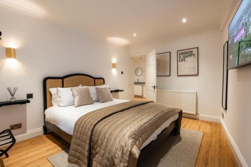 a bedroom with a large bed and a television at Hamilton Residence - Private Main Door 1BR in Glasgow