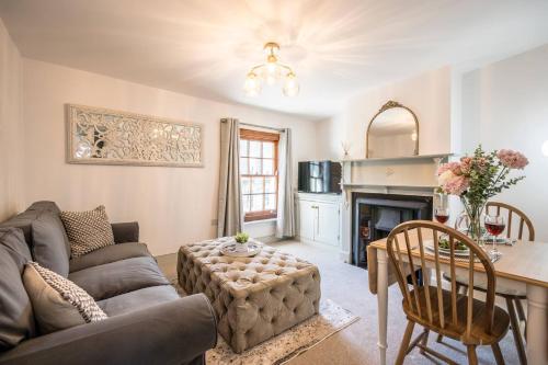 a living room with a couch and a table at 3a Childs Yard, Southwold in Southwold