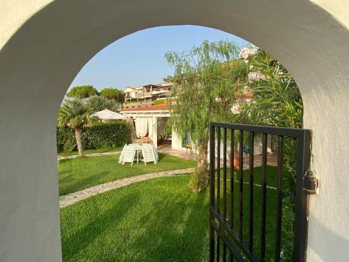 an archway leading to a yard with a house at Villa Taurus Costa dei Monaci Parghelia Tropea in Parghelia