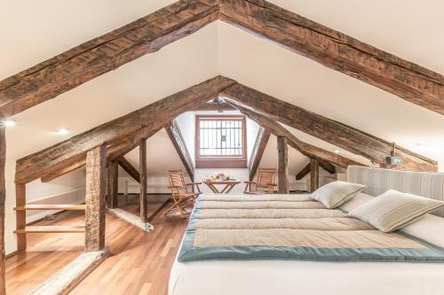 a bedroom with a large bed and wooden beams at Cà Grassi 3 Venetian Terrace in Venice