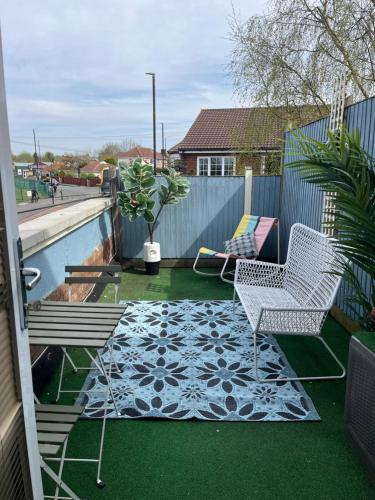 a patio with two chairs and a pool at Modern apartment with terrace in Bristol