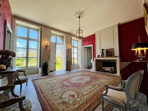 un grand salon avec un grand tapis et une cheminée dans l'établissement Chateau de Gourmont Dream Stay in a Norman Castle, à Saint-Germain-de-Varreville