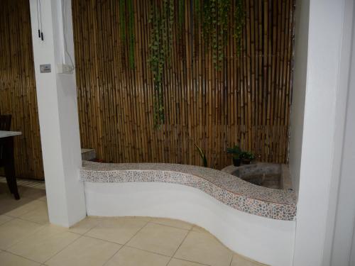 a bath tub with a mosaic design in a bathroom at Cozy at Kohlarn in Ko Larn