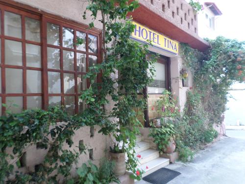 a building with a bunch of ivy growing on it at Tina Hotel in Chania Town