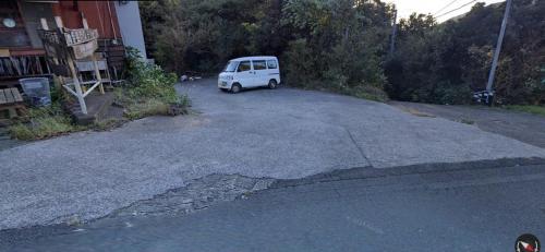 a small white van parked in a driveway at 南伊豆ランドホピア Minami Izu Land Hopia in Minamiizu