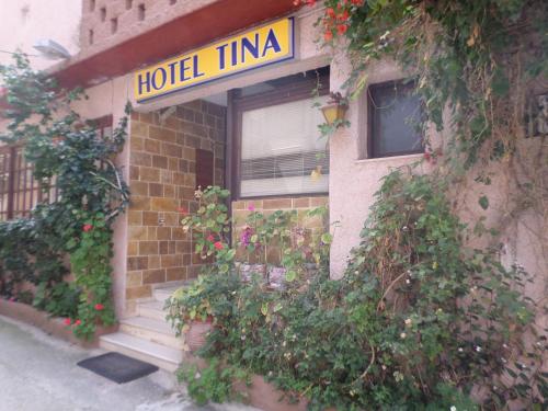 a building with a hotel tima sign on the front at Tina Hotel in Chania Town