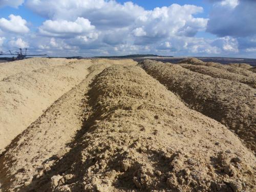 a large pile of dirt in a field with a sky at Heidebistro in Commerau