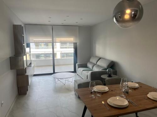 a living room with a table and a couch at Flamenca Village Holiday in Playa Flamenca
