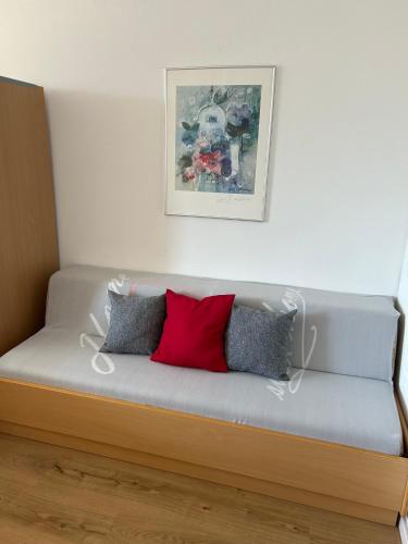 a couch with three pillows on it in a room at Ferienwohnung Predigtstuhl Resort in Sankt Englmar