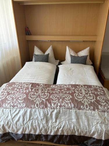 a bed with two pillows on top of it at Ferienwohnung Predigtstuhl Resort in Sankt Englmar