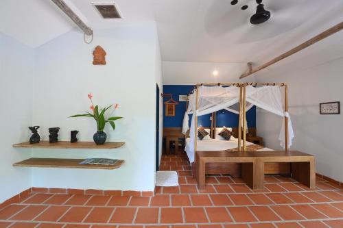 a bedroom with a bed with a canopy at Whale Island Resort in Dam Mon