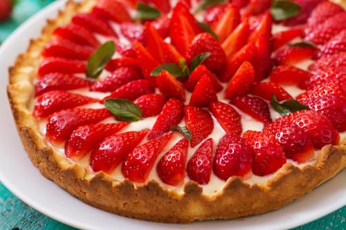 a strawberry cream cheese pie with strawberries on top at Hotel Sole - Limone in Limone sul Garda