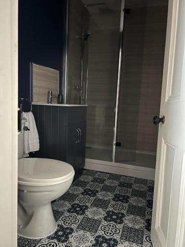 a bathroom with a toilet and a shower at Katys Cottage, Barnoldswick in Barnoldswick