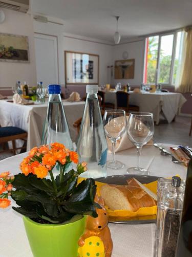 two bottles on a table with a plate of food at Hotel Sporting in Casarsa della Delizia