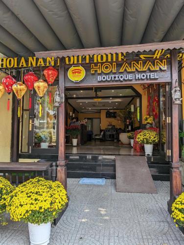 an entrance to a hotel with flowers in front of it at Hoianan Boutique Hotel in Hoi An