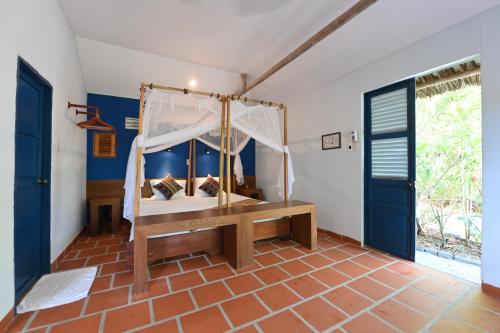 a bedroom with a bed with a canopy at Whale Island Resort in Dam Mon