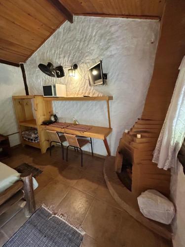 a room with a desk and a table in a house at Vale do Piemonte "Chalés " in Santo Antônio do Pinhal
