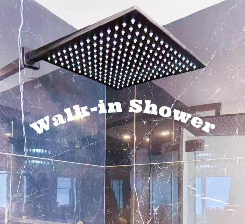 a window with a wall in showcase sign on it at Sydney Harbour and CBD View Penthouse with Free Parking in Sydney