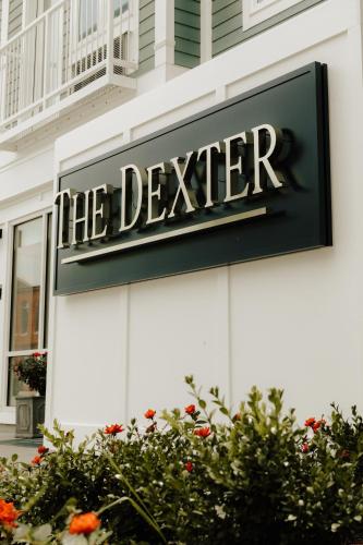 a sign for the dealer on the side of a building at The Dexter by Kasa in Elk Rapids